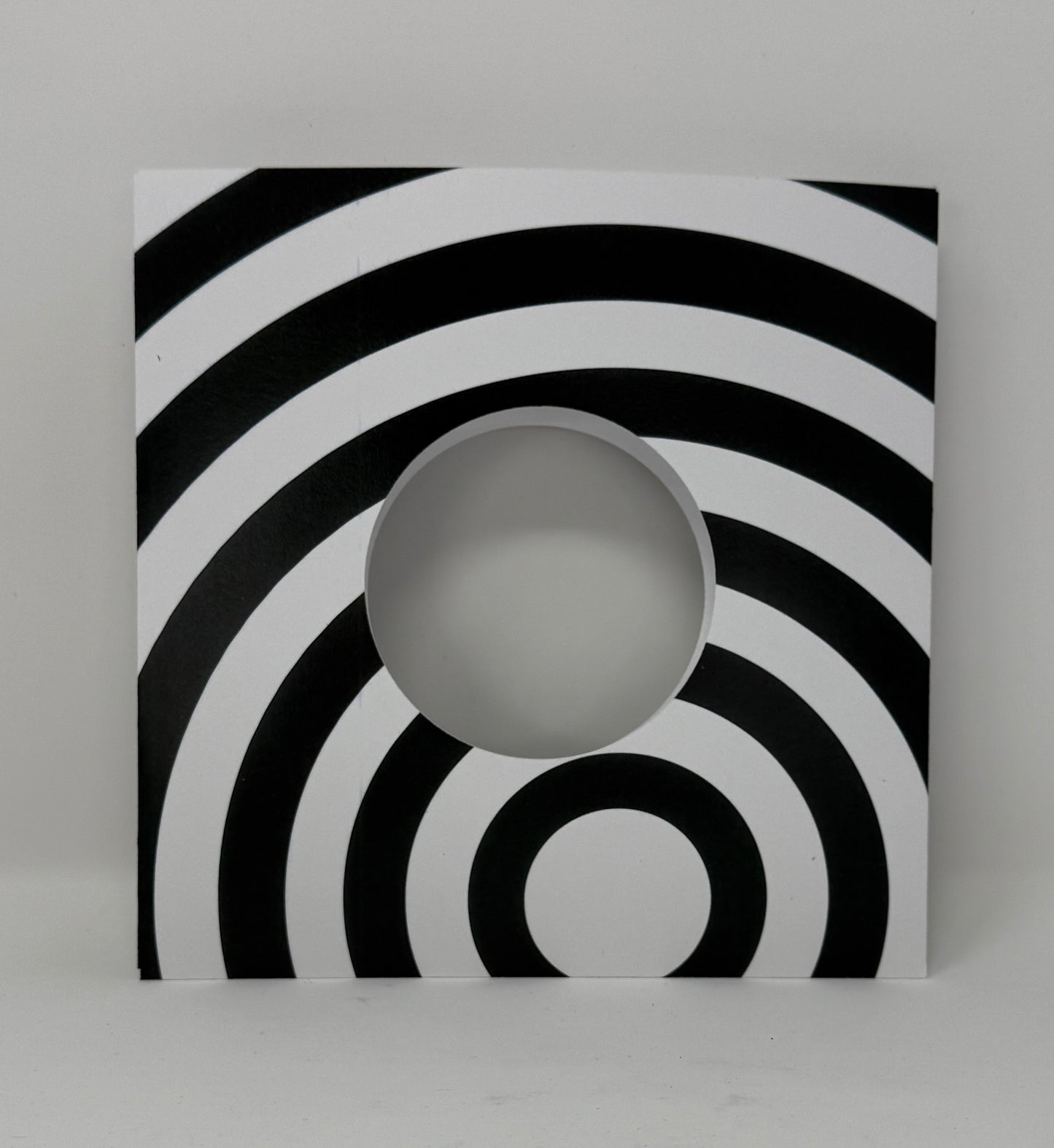 7" Record sleeve in heavy cardstock in black and white radiating circle op art pattern