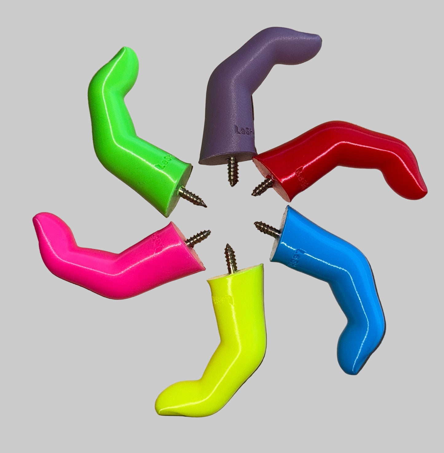 Colorful plastic hooks finger shaped wall hooks made of 3D printed plastic on a white surface